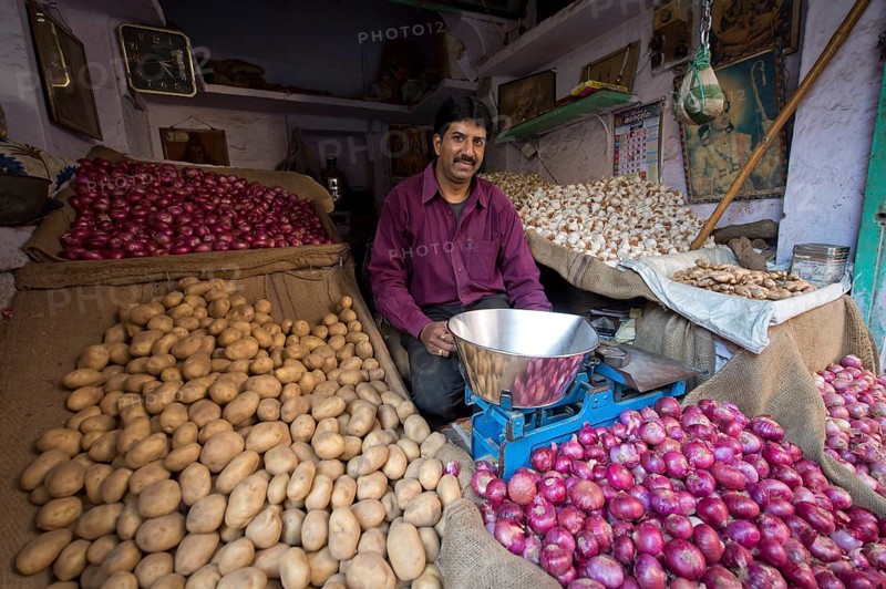 Potato and onion trader at his market stand