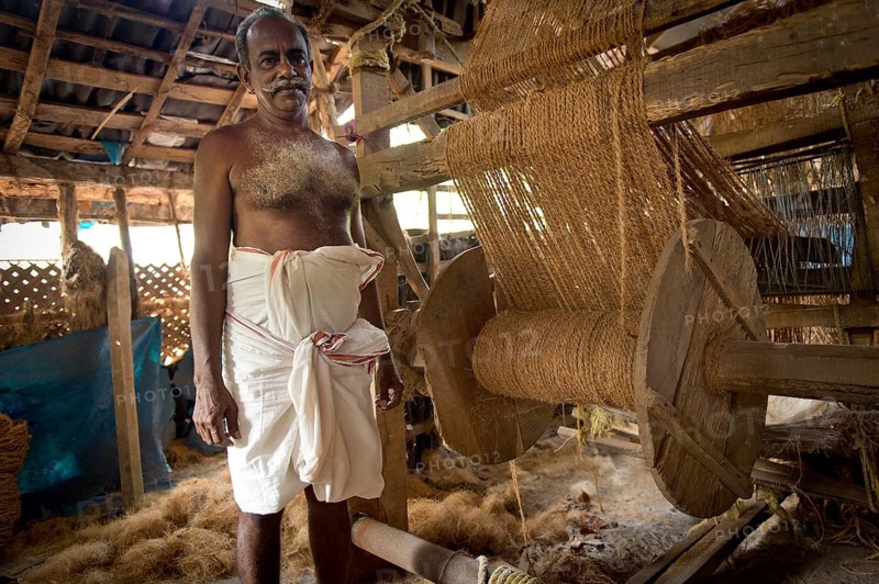 Man making ropes from coconut fibres in a small business