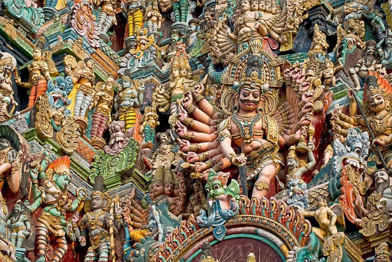Colourful statues of gods and demons on the Gopuram or Gopura gate tower