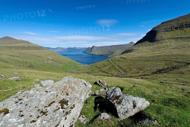 View over boulders and the village of Funningur towards Djupini Fjord