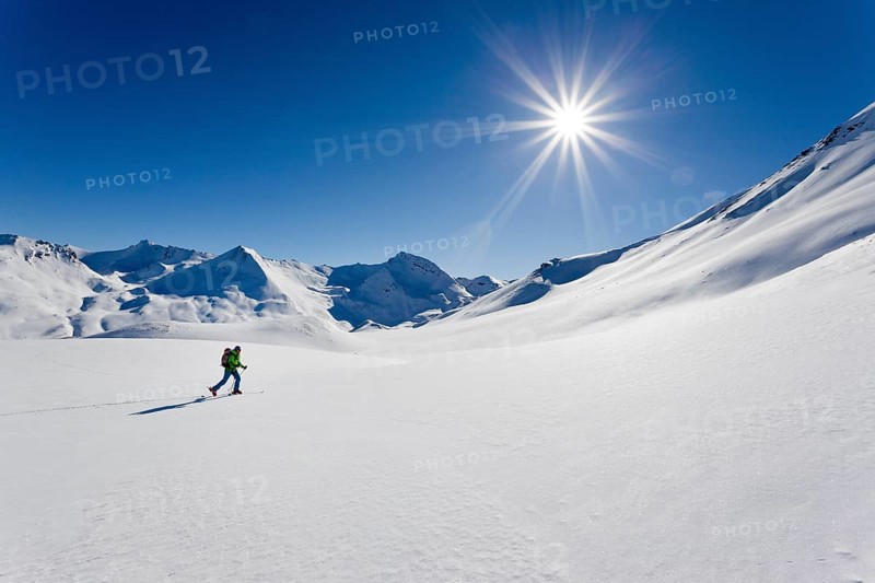 Cross-country skier in a snowy winter landscape