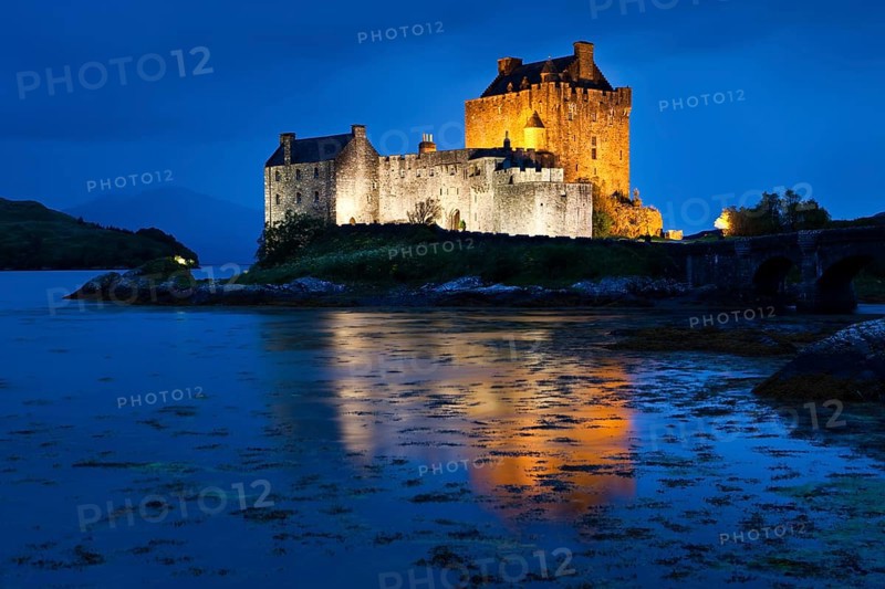 Eilean Donan Castle illuminated at dusk