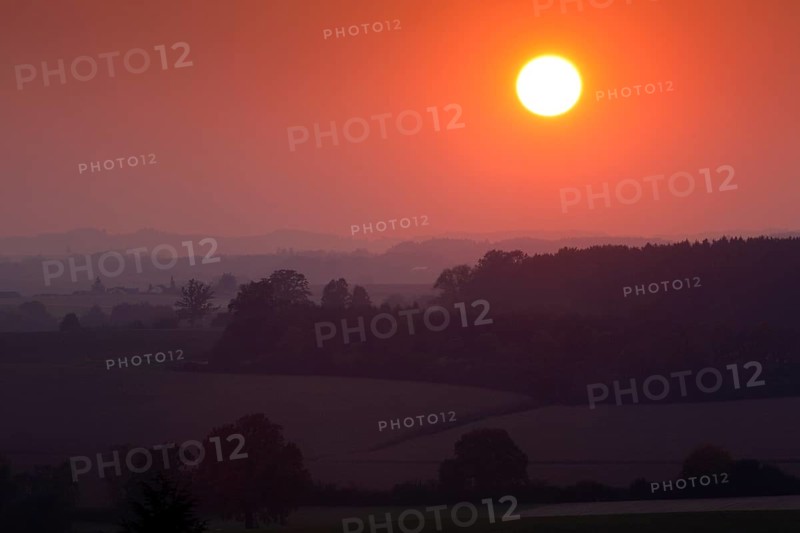 Sunset over a wooded landscape