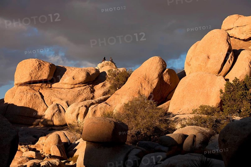Climbers on top of a rock