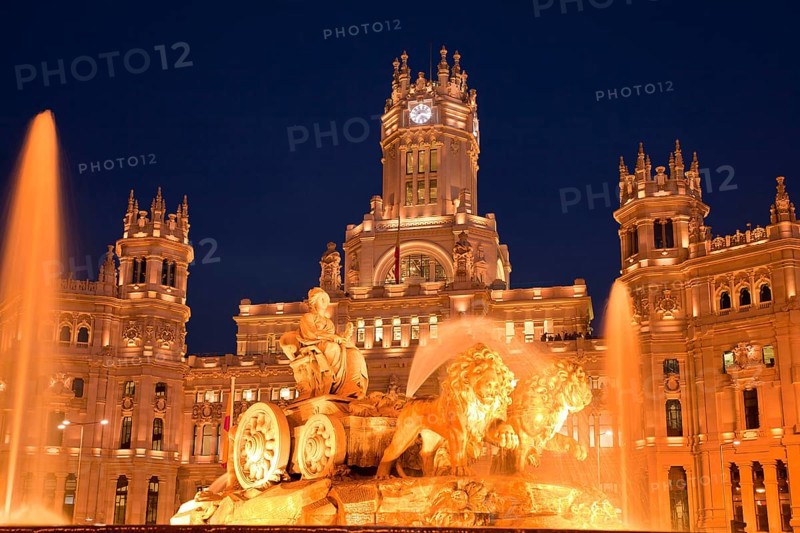 Illuminated Fuente de Cibeles fountain in front of the Palacio de Comunicaciones