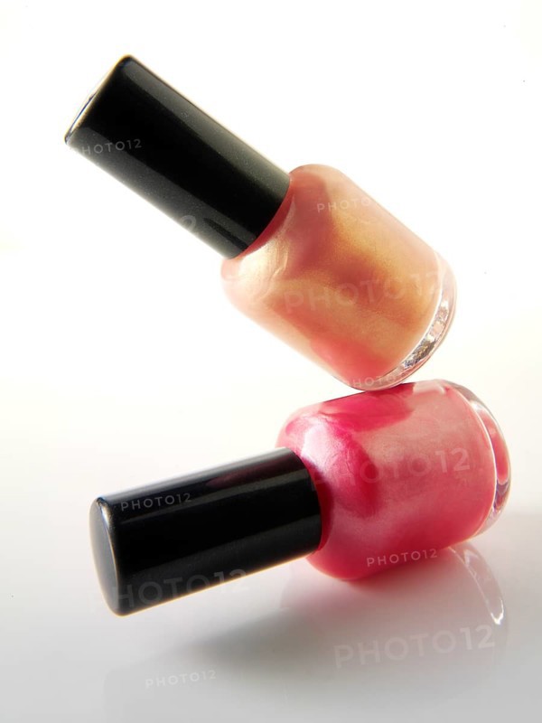Two nail varnish bottles balanced on each other