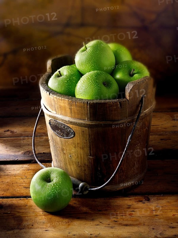 Granny Smith apples in a wooden bucket