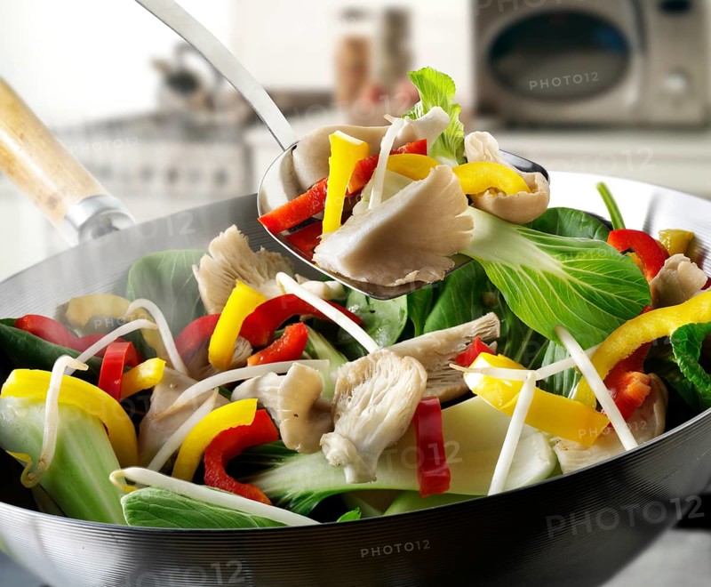 Stir-fry vegetables in a wok