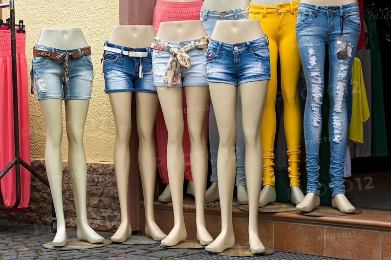 Legs of mannequins with jeans and hot pants