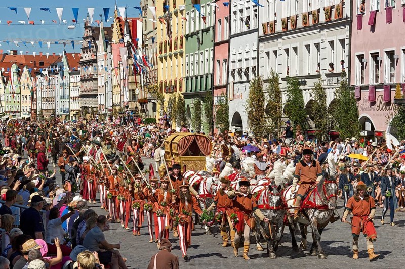 Horse-drawn golden bridal carriage and escorts