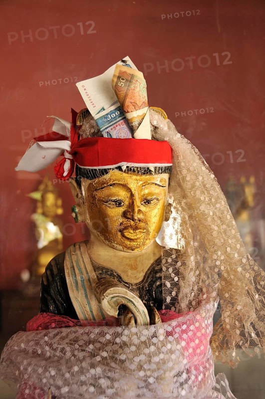 Nat character with a money offering
