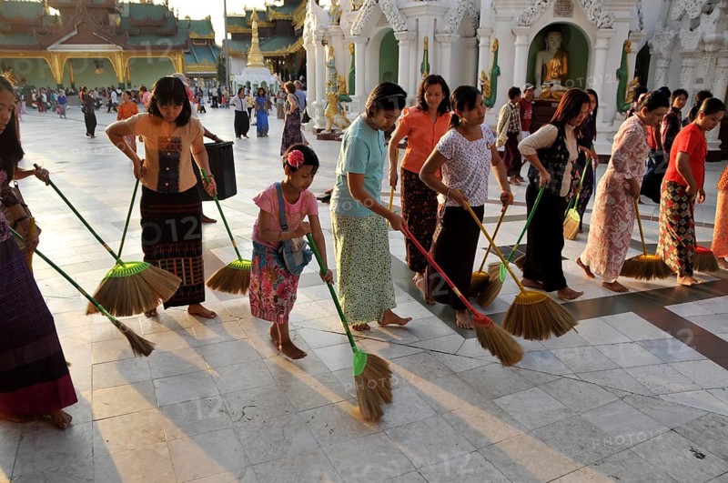 Women sweeping the floor as a ritual action