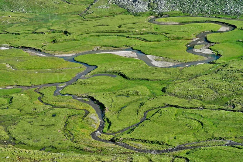 Meandering stream through the Timmelsalm alpine pasture
