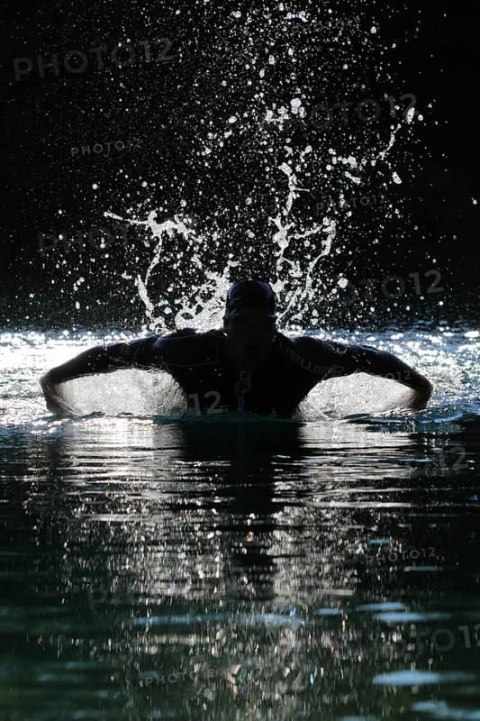 Man swimming with a butterfly stroke in a lake in Sonthofen