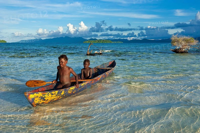 Boys in a canoe in the Marovo Lagoon
