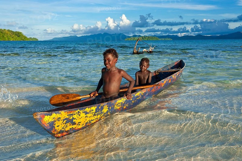 Boys in a canoe in the Marovo Lagoon