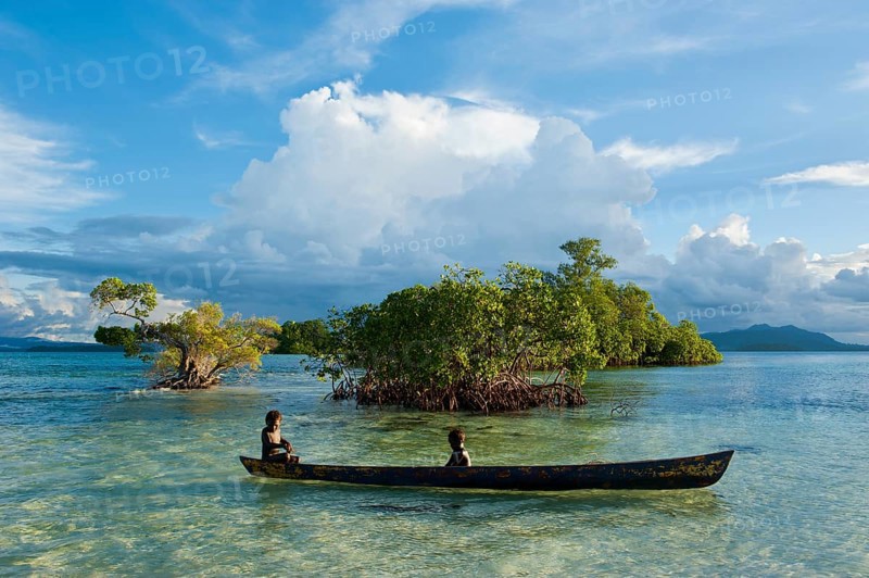 Boys in a canoe in the Marovo Lagoon