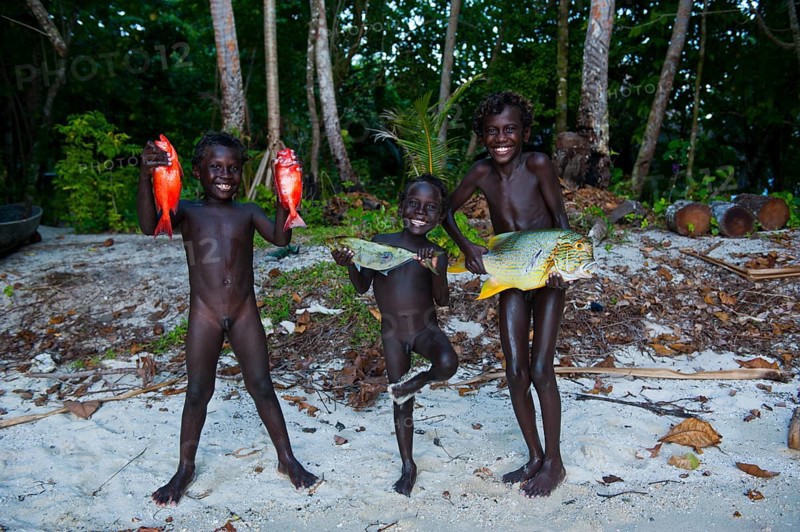 Boys proudly showing the fish they caught