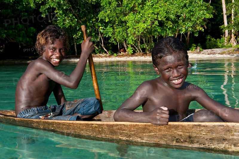 Local boys in a canoe in the Marovo Lagoon