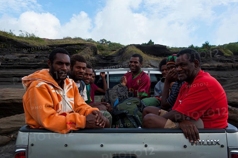 People on a pickup driving through the volcanic ash of Mount Yasur volcano