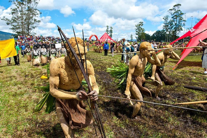 Members of a tribe in colourfully decorated costumes with face and body paint at the traditional sing-sing gathering