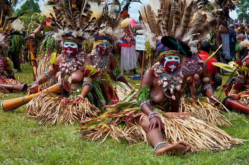 Women in colourfully decorated costumes with face paint at the traditional sing-sing gathering