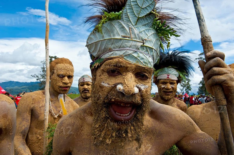 Members of a tribe in colourfully decorated costumes with face and body paint at the traditional sing-sing gathering