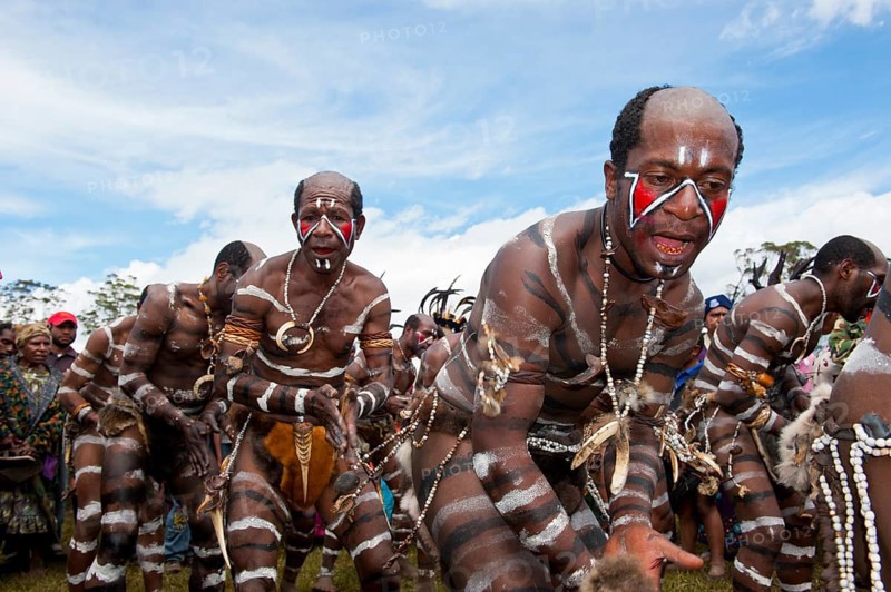 Members of a tribe with face and body paint at the traditional sing-sing gathering