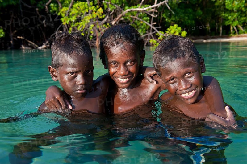 Local boys in the water of the Marovo Lagoon