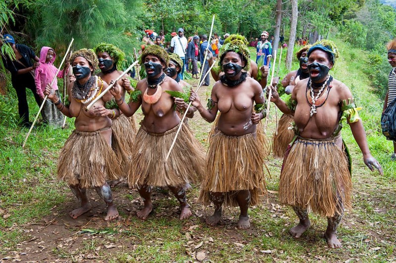 Colourfully decorated women with face paint are celebrating at the traditional Sing Sing gathering in the highlands