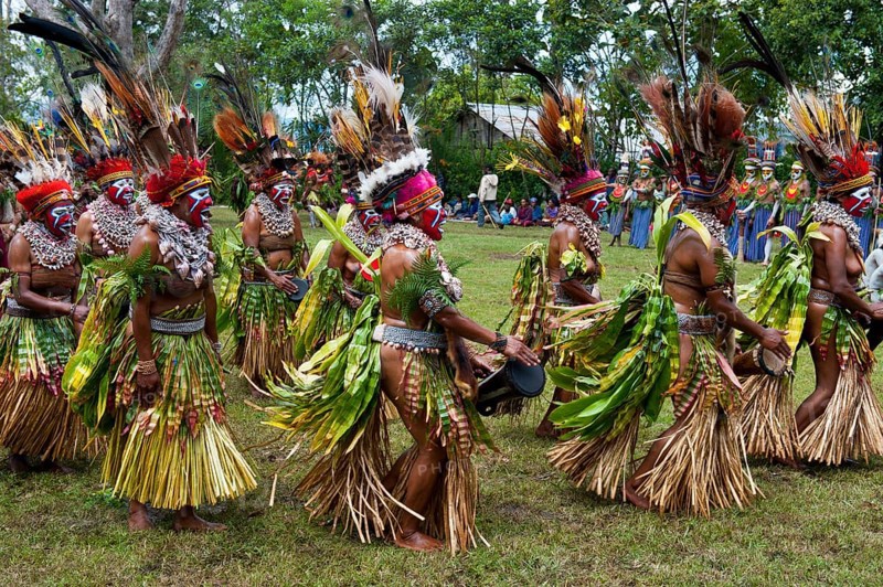 Tribal members in colourful decorations and face paint are celebrating at the traditional Sing Sing gathering in the highlands