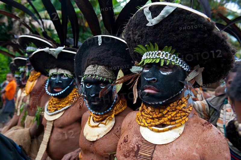 Black decorated and painted tribesmen celebrating the traditional Sing Sing in the highlands