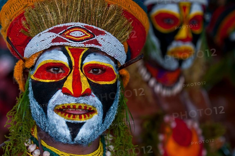 Colourfully decorated and painted men celebrating the traditional Sing Sing in the highlands