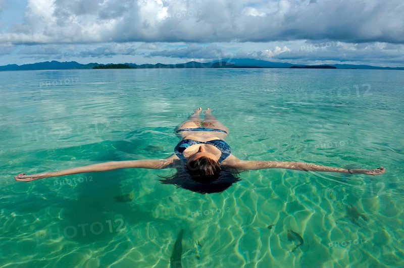 Tourist floating in the clear water of the Marovo Lagoon
