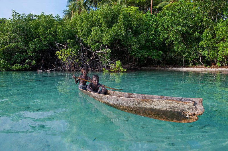 Local boys in a canoe in the Marovo Lagoon