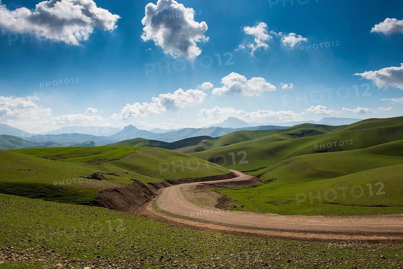Road sneaking through the green hilly landscape