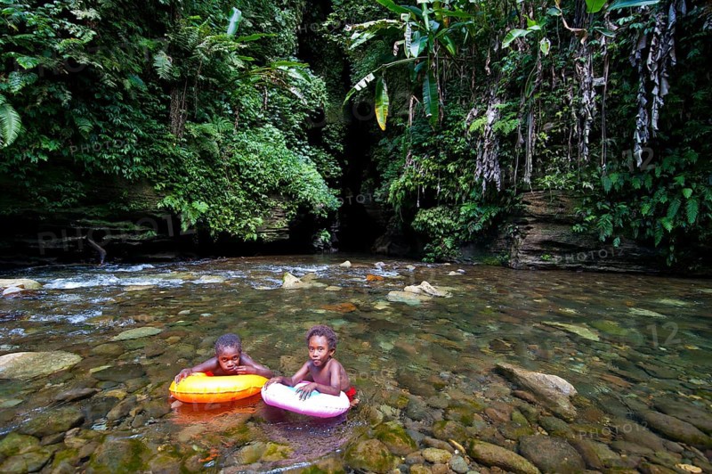 Children bathing in front of the Millennium Cave