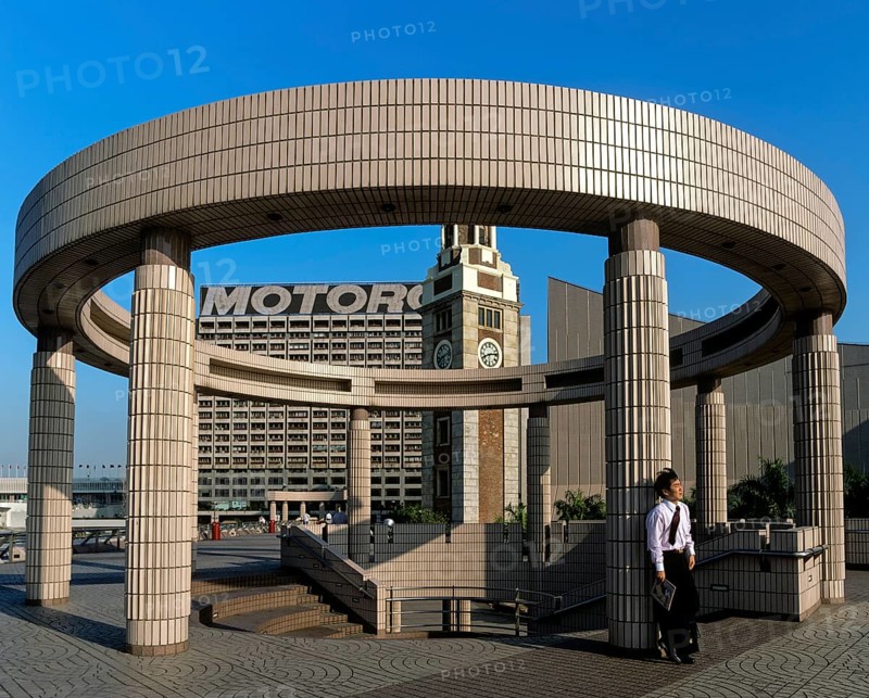 Man leaning against a pillar on a round structure at the Cultural Centre