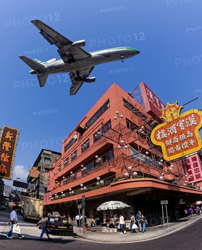 Cathay Pacific aircraft approaching Kai Tak Airport over the rooftops of Kowloon