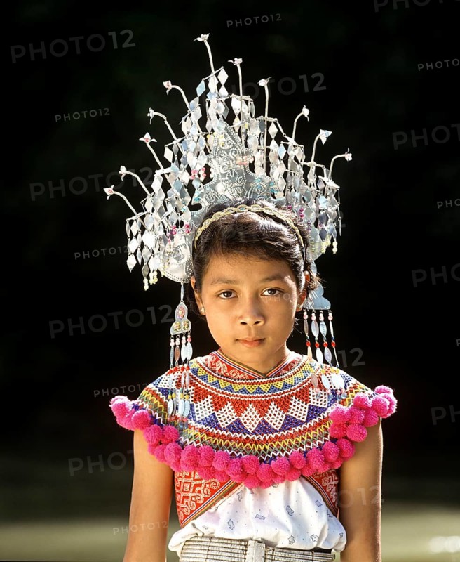 Girl of the ethnic group of the Iban people wearing traditional dress with a headdress
