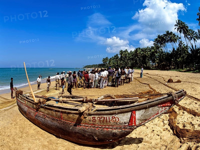 Fishing boat and fishermen on the beach