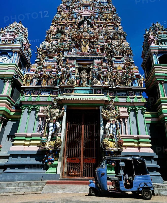 Tuk tuk in front of the gopuram or gate tower at the entrance to the Hindu temple of Colombo II