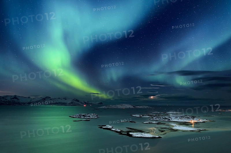 Fjord with islands in winter and the northern lights