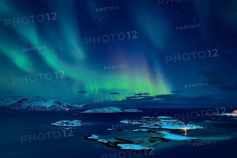 Fjord with islands in winter and the northern lights