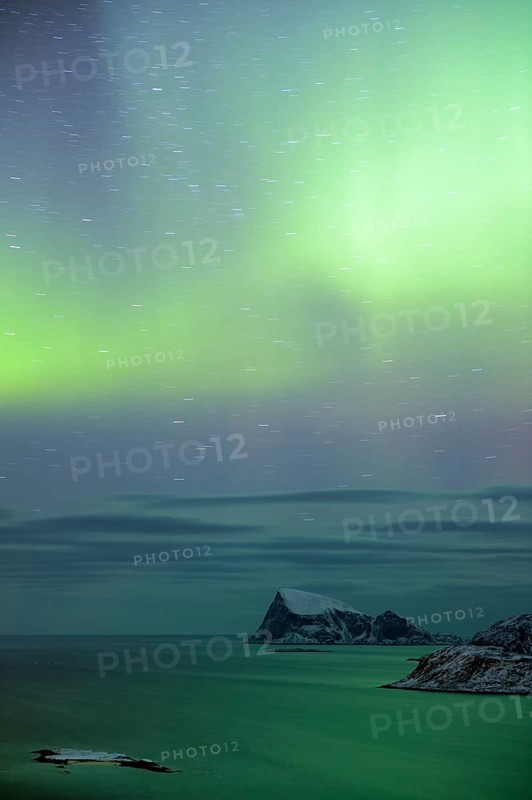 Fjord with islands in winter and the northern lights