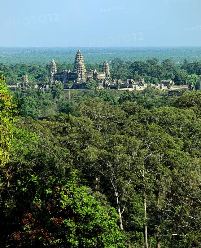 View from Phnom Bakheng towards Khmer Temple with its towers rising out of the jungle