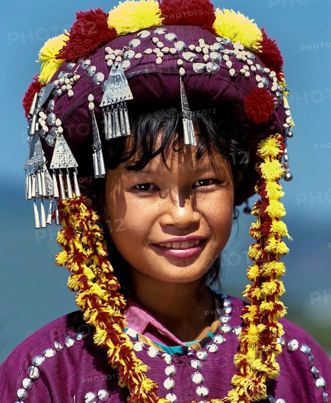 Lisu girl wearing a colourful headdress and the traditional costume of the mountain people