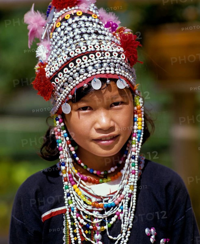 Akha girl wearing a colourful headdress and the traditional costume of the mountain people