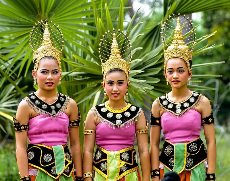 Three young women wearing traditional costumes