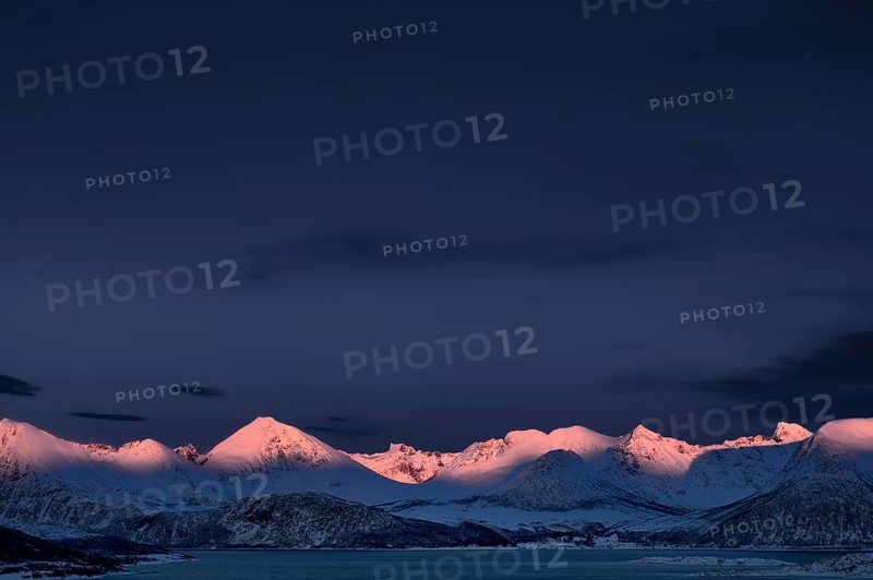 Fjord with mountain peaks during the blue hour